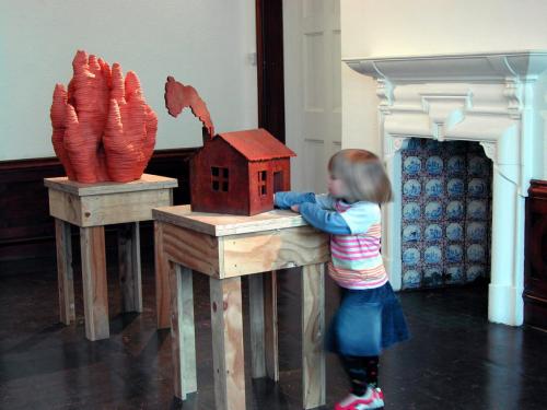 foreground: Home on the Range, Anderson Inge  background: Fire, Bruce Gernand, Home on the Range, cast iron, 48cm (H), 2003 Fire, ceramic, 64cm (H), 2002